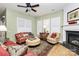 Comfortable living room featuring a fireplace, decorative rug, and lots of natural light at 9119 Gander Dr, Charlotte, NC 28277