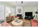 Comfortable living room featuring a fireplace, decorative rug, and a TV at 9119 Gander Dr, Charlotte, NC 28277