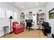 Bright home office with natural light from the windows, built-in shelving, and a desk at 9119 Gander Dr, Charlotte, NC 28277