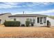 Back of house with a screened porch, patio, well maintained lawn and hedges for privacy at 9119 Gander Dr, Charlotte, NC 28277
