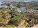 Aerial view of the property showcasing its lakeside location, lush greenery, and proximity to the lake at 9135 Fair Oak Dr, Sherrills Ford, NC 28673