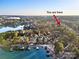 Aerial view shows property's location on the water, multiple docks, and the surrounding wooded landscape at 9135 Fair Oak Dr, Sherrills Ford, NC 28673