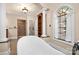Luxurious bathroom features a soaking tub, elegant columns, a large window, and separate shower at 9135 Fair Oak Dr, Sherrills Ford, NC 28673