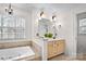 Bright bathroom with a jacuzzi tub, vanity, and large window that offers natural light and garden views at 9135 Fair Oak Dr, Sherrills Ford, NC 28673