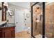 Bathroom featuring a glass enclosed shower and a vanity with dark countertop at 9135 Fair Oak Dr, Sherrills Ford, NC 28673