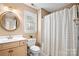 Cozy bathroom showcasing a vanity, toilet, and shower with a stylish patterned curtain at 9135 Fair Oak Dr, Sherrills Ford, NC 28673