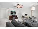 Spacious bonus room features a cozy seating area, desk, television, and a decorative ceiling fan at 9135 Fair Oak Dr, Sherrills Ford, NC 28673