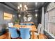 Formal dining room with dark gray walls, modern chandelier, and hardwood floors at 9135 Fair Oak Dr, Sherrills Ford, NC 28673