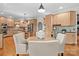 Bright kitchen features natural wood cabinets, granite counters, a central island, and a breakfast nook with a round table at 9135 Fair Oak Dr, Sherrills Ford, NC 28673
