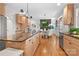 Open-concept kitchen boasts an island with a granite countertop, wood cabinets, stainless steel appliances, and seamless transition to living spaces at 9135 Fair Oak Dr, Sherrills Ford, NC 28673