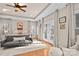 Serene bedroom with tray ceilings, natural light, French doors, neutral decor, and a comfortable seating area at 9135 Fair Oak Dr, Sherrills Ford, NC 28673
