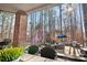 Covered patio with brick support column, outdoor fireplace, and wooded backyard view at 9135 Fair Oak Dr, Sherrills Ford, NC 28673