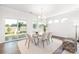 Bright dining area with a glass table and chairs, adjacent to sliding doors at 103 Noah Ln, Troutman, NC 28166