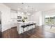 Bright kitchen with an island, bar stool seating, stainless steel appliances, and pendant lighting at 103 Noah Ln, Troutman, NC 28166