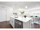 Bright kitchen featuring stainless steel appliances, island with sink, and modern white countertops at 103 Noah Ln, Troutman, NC 28166