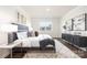 Spacious bedroom with large windows, a comfortable bed, and decorative accents at 103 Noah Ln, Troutman, NC 28166