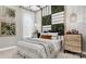 This is a modern bedroom featuring a unique decorative accent wall, pendant lighting, and neutral color scheme at 1043 Rabbit Hill Ln, Monroe, NC 28110