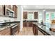 Modern kitchen with stainless steel appliances, dark countertops, and a functional island with a sink at 1043 Rabbit Hill Ln, Monroe, NC 28110