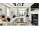 Bright and open living room area featuring modern furnishings, a fireplace, and seamless flow to the dining area at 1043 Rabbit Hill Ln, Monroe, NC 28110