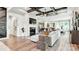 Open-concept living room with a fireplace, ample natural light, and a view into the kitchen and dining areas at 1043 Rabbit Hill Ln, Monroe, NC 28110