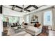 Cozy living room featuring wood floors, a decorative ceiling fan, and a comfortable seating area with natural light at 1043 Rabbit Hill Ln, Monroe, NC 28110