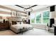 Bright main bedroom featuring large windows, a decorative chandelier, and stylish striped accent wall at 1043 Rabbit Hill Ln, Monroe, NC 28110