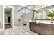 Bathroom featuring a glass shower with white tile surround, a modern vanity, and a view to the walk-in closet at 1047 Rabbit Hill Ln, Monroe, NC 28110