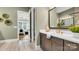 Bathroom featuring a modern vanity, a large mirror, designer fixtures, and a glimpse into the main bedroom at 1047 Rabbit Hill Ln, Monroe, NC 28110
