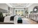 Bright primary bedroom with hardwood floors, tray ceiling, modern decor, and large windows at 1047 Rabbit Hill Ln, Monroe, NC 28110