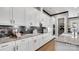 Modern kitchen features white cabinets, granite countertops, stainless steel appliances, and dark backsplash at 1047 Rabbit Hill Ln, Monroe, NC 28110