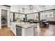 Open concept kitchen and living area with a large center island, granite countertops, and hardwood floors at 1047 Rabbit Hill Ln, Monroe, NC 28110