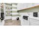 Bright laundry room with white cabinets, stylish decor, and modern appliances at 1047 Rabbit Hill Ln, Monroe, NC 28110