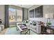 Comfortable living room with exposed brick, a plush sectional sofa, and lots of natural light at 1047 Rabbit Hill Ln, Monroe, NC 28110