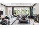 Bright and airy living room featuring a large window, designer sofas, stylish decor, and access to an outdoor patio at 1047 Rabbit Hill Ln, Monroe, NC 28110