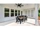 Covered outdoor dining area with a ceiling fan, and seating for eight, perfect for entertaining at 1047 Rabbit Hill Ln, Monroe, NC 28110