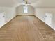 Expansive bedroom with neutral carpeting, two closets, a ceiling fan, and a window for natural light at 1062 Baldwin Dr, Lancaster, SC 29720