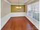 Bright dining room features hardwood floors, chandelier, and wainscoting at 1062 Baldwin Dr, Lancaster, SC 29720