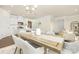 Open-concept dining room connected to kitchen, featuring a stylish table with seating for six at 109 Noah Ln, Troutman, NC 28166