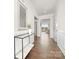 Inviting hallway featuring elegant wainscoting, a decorative mirror, and views into the bright living space at 109 Noah Ln, Troutman, NC 28166