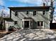 Backyard featuring a large concrete patio, green siding, and multiple windows at 10906 Falls Branch Ln, Charlotte, NC 28214