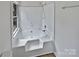 Bright bathroom features a soaking tub with tile surround and a showerhead at 10906 Falls Branch Ln, Charlotte, NC 28214