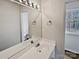 Bright bathroom with a double sink vanity and a view of the outdoors at 10906 Falls Branch Ln, Charlotte, NC 28214