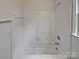 Bathroom featuring shower and tub with white tile at 10906 Falls Branch Ln, Charlotte, NC 28214