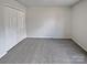 Bedroom featuring neutral paint, closet doors, and carpet at 10906 Falls Branch Ln, Charlotte, NC 28214