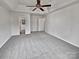 Spacious bedroom featuring a vaulted ceiling, carpeted flooring, and access to multiple doors at 10906 Falls Branch Ln, Charlotte, NC 28214