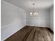 Dining room features wood floors, neutral paint, chandelier, and crown molding at 10906 Falls Branch Ln, Charlotte, NC 28214