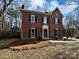 Charming brick home with classic design details, featuring a well-manicured lawn at 10906 Falls Branch Ln, Charlotte, NC 28214