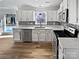 Well-lit kitchen with white cabinets, stainless steel appliances, and modern backsplash at 10906 Falls Branch Ln, Charlotte, NC 28214