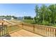 Wooden back deck shows a neighborhood, trees, and clear blue skies at 111 Rustling Waters Dr, Mooresville, NC 28117