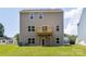 Back exterior shows a house with a wooden deck, well-maintained lawn, and exterior lights at 111 Rustling Waters Dr, Mooresville, NC 28117